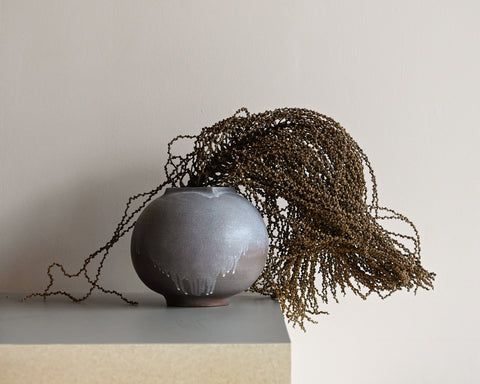 dried fishtail palm inflorescence in clam lab ceramic vase