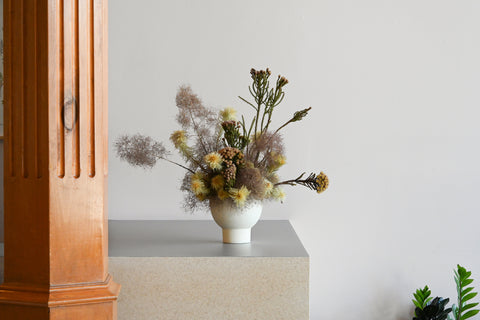 white ceramic vase arrangement dried flowers